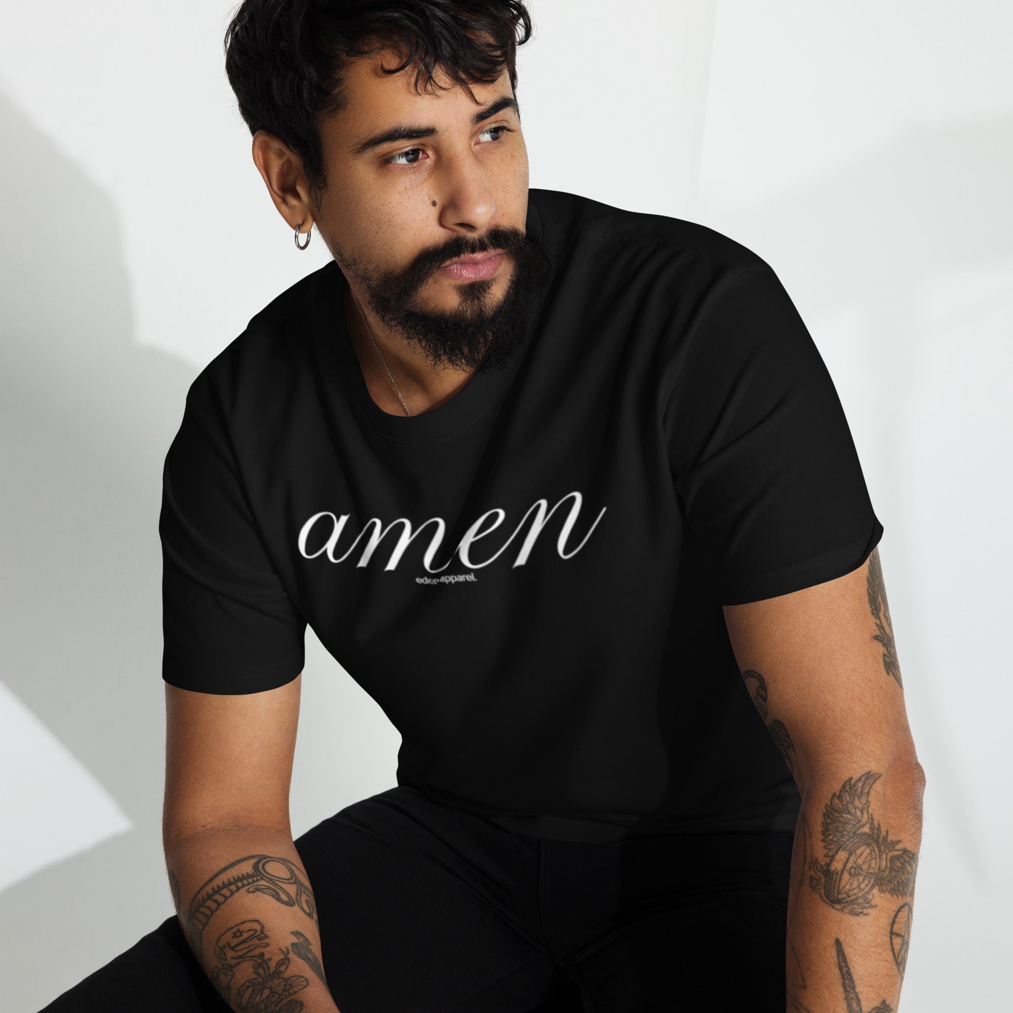 Man wearing a black t-shirt with 'amen' text on a white background