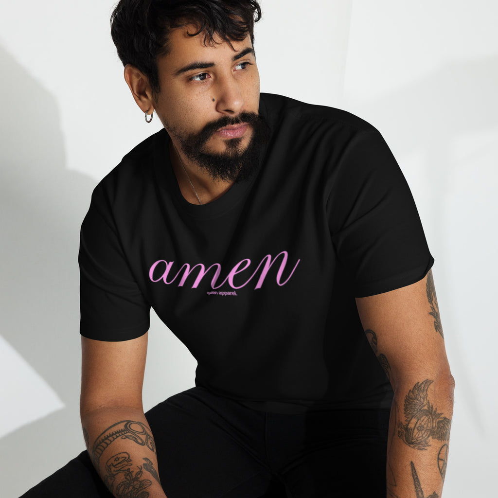 Man wearing a black t-shirt with 'amen' in pink text on a white background