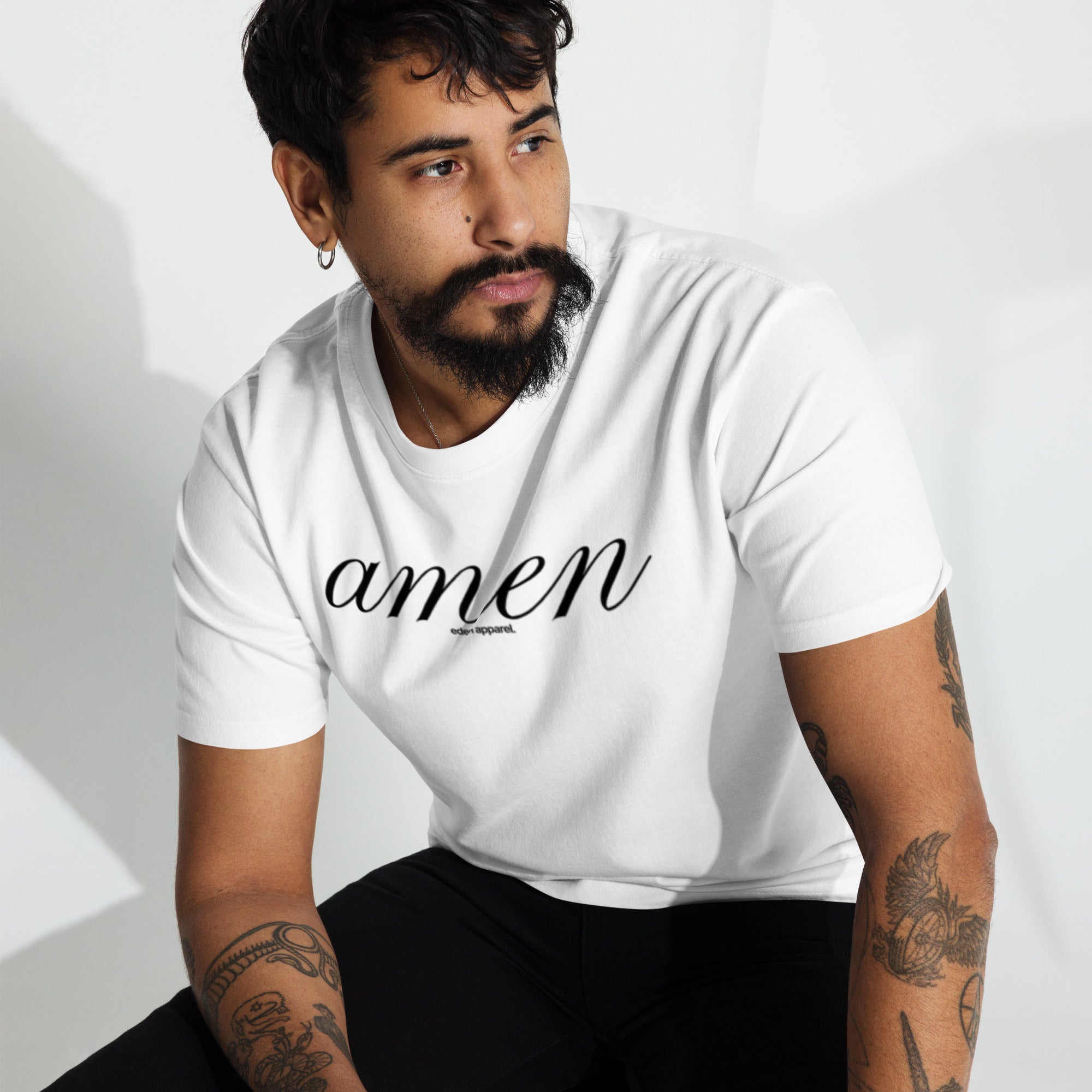 Man wearing a white t-shirt with black 'amen' printed on it against a white background